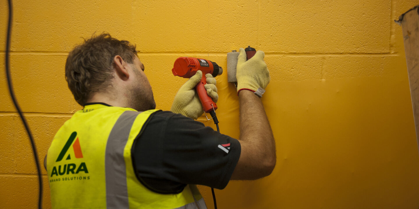 Installation of printed textured wall film on to block wall at Wolves football stadium